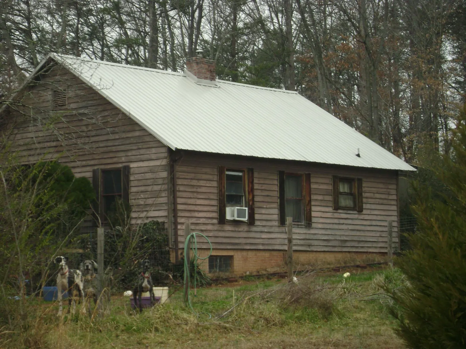 White metal roof on an old wood sided farmhouse, from a Metal Roof Installation job in Lacota